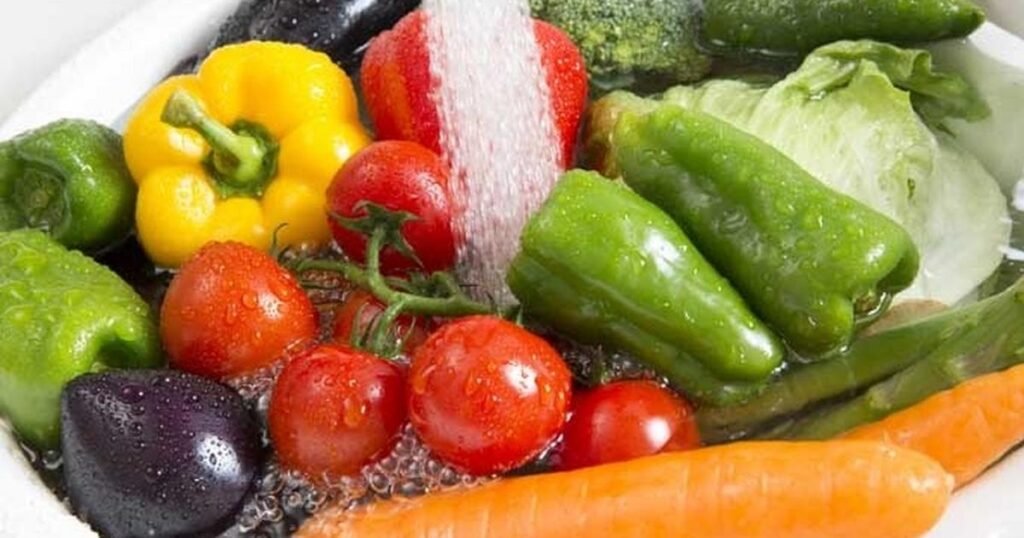 A built-in colander integrated into the sink, with fresh vegetables being rinsed, showcasing its convenience and functionality.